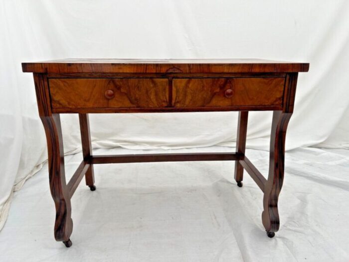 1900s antique desk american empire on caster wheels two drawers flame mahogany veneer 6351