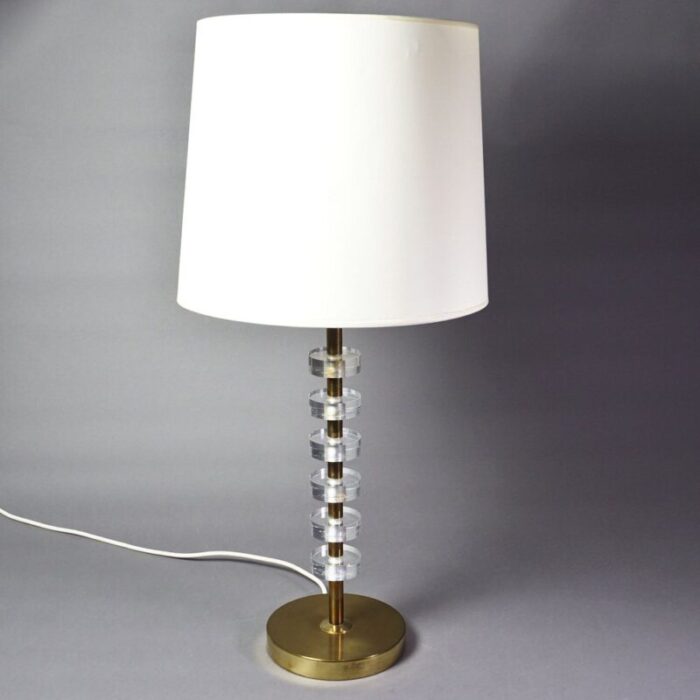 scandinavian modern brass and acrylic glass table lamp in the style of carl fagerlund 1